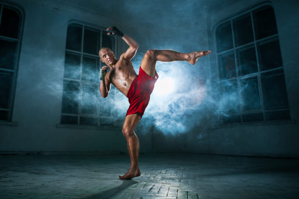 the-young-man-kickboxing-in-blue-smoke.jpg