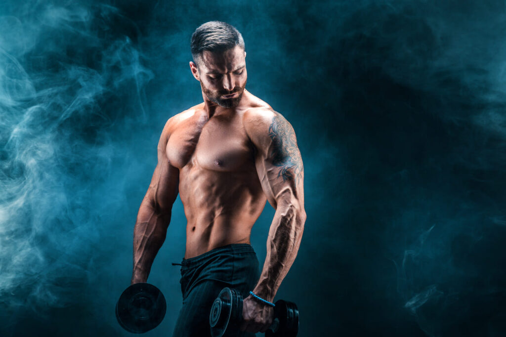 young-ripped-man-bodybuilder-with-perfect-abs-shoulders-biceps-triceps-and-chest-posing-with-a-dumbbell.jpg